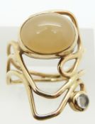 A 9ct gold ring set with two moonstone cabochons, 5.5g, size P