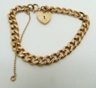 A 9ct gold curb link bracelet with heart padlock, 17.6g