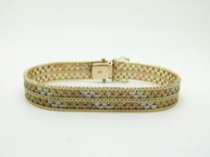 A 9ct gold tri-colour bracelet with segmented textured links, 20.7g
