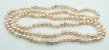 A cultured pearl necklace made up of peach, pink and cream beads