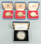 Four cased 44mm Royal commemorative silver crowns
