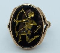 A 9ct gold ring set with a carved hematite cabochon, 5.9g, size I