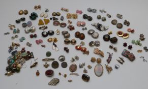 A large collection of earrings including Attitude Paris, enamel and glass examples