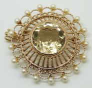 A 9ct gold brooch / pendant set with a round cut citrine and pearls, 14g