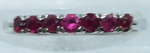 An 18ct white gold ring set with rubies, 2.4g, size K