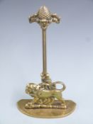 19thC brass door stop/porter with figural lion decoration and pineapple finial