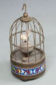 A c1950s bird-song automaton alarm clock, the case with cloisonné decoration to base, the orb dial