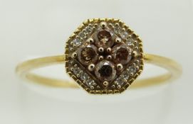 A 9ct gold ring set with four champagne diamonds and further diamonds, 1.6g, size P