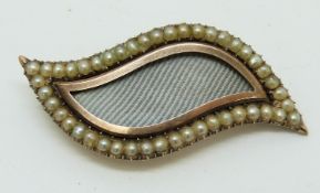 Victorian mourning/ love brooch in the shape of an eye set with seed pearls to the border, 3.6 x 1.