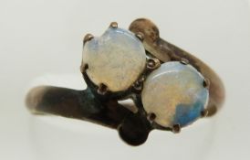 A yellow metal ring set with two opals, 1.5g, size O