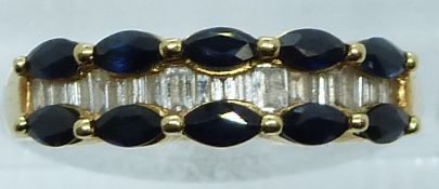 An 18ct gold ring set with marquise cut sapphires and baguette cut diamonds, 4.1g, size P