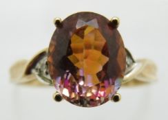 A 9ct gold ring set with an oval cut mystic topaz and diamonds, 2.2g, size P