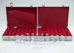 Two 32 wristwatch carry cases and a collection of plastic watch display stands.