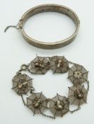 A silver bangle and filigree bracelet