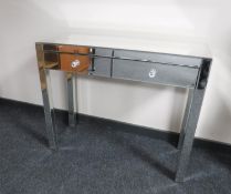 A contemporary mirrored dressing table fitted two drawers