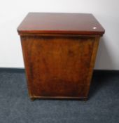 A mid 20th century treadle sewing machine in walnut cabinet (locked)