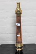 A vintage brass and copper fire hose nozzle