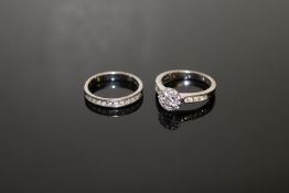 An 18ct white gold diamond cluster ring, set with diamond shoulders, approximately 0.