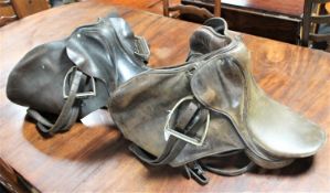 Two leather saddles