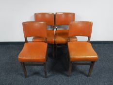 A set of four oak leather upholstered dining chairs