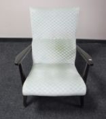 A mid 20th century stained teak framed armchair upholstered in a green fabric