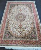 A Keshan rug on beige ground,