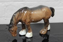 A Beswick china figurine : Grazing Shire, model 1050, brown, gloss, height 14 cm.