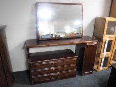 A late 20th century mahogany effect dressing table fitted a cupboard and three drawers