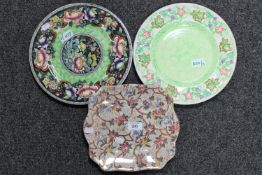 A Maling chestnut chintz oblong cake plate, together with two circular Maling plaques.