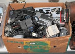 A box containing a Pentax ME Super camera with lens, assorted camera accessories,