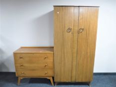 A mid 20th century walnut double door wardrobe together with a three drawer chest