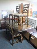 An Ercol refectory dining table together with a set of four ladder back chairs