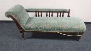 A Victorian mahogany chaise longue upholstered in green floral fabric