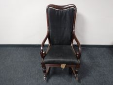 A Victorian mahogany scroll arm rocking chair
