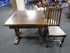 An early 20th century oak pull out dining table together with two chairs