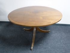 A circular inlaid mahogany Regency style dining table