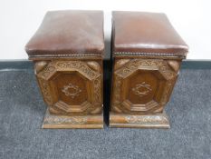A pair of early 20th century carved oak leather topped storage boxes
