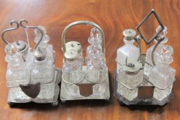 Three antique four-piece cruet sets on plated stands