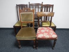 A pair of oak rail back chairs together with two antique mahogany chairs and an oak bar stool