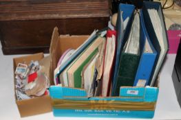 A box containing Strand stamp album, folder of stamps, loose stamps etc