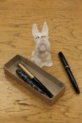 A Beswick figure of a terrier together with three vintage pens by Conway Stewart and Parker.