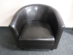 A faux leather tub chair