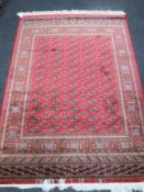 A Bokhara rug on red ground,