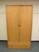 A Barker & Stonehouse light oak wardrobe fitted with a drawer,