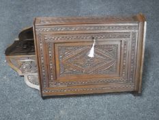 A heavily carved hanging oak corner cupboard CONDITION REPORT: 98cm high by 55cm