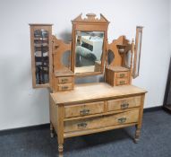 An early 20th century pine dressing chest with triple mirror