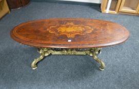 An oval inlaid mahogany coffee table on a gilt metal base CONDITION REPORT: The top