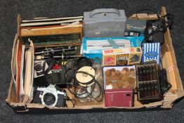 A box containing copper coins, Pentax camera, Polaroid slide mounter, Sony microphone,