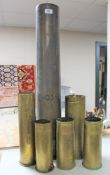 Six brass ammunition shell casings CONDITION REPORT: The large shell has no base.