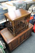 An oak blanket box together with a nest of three oak tables